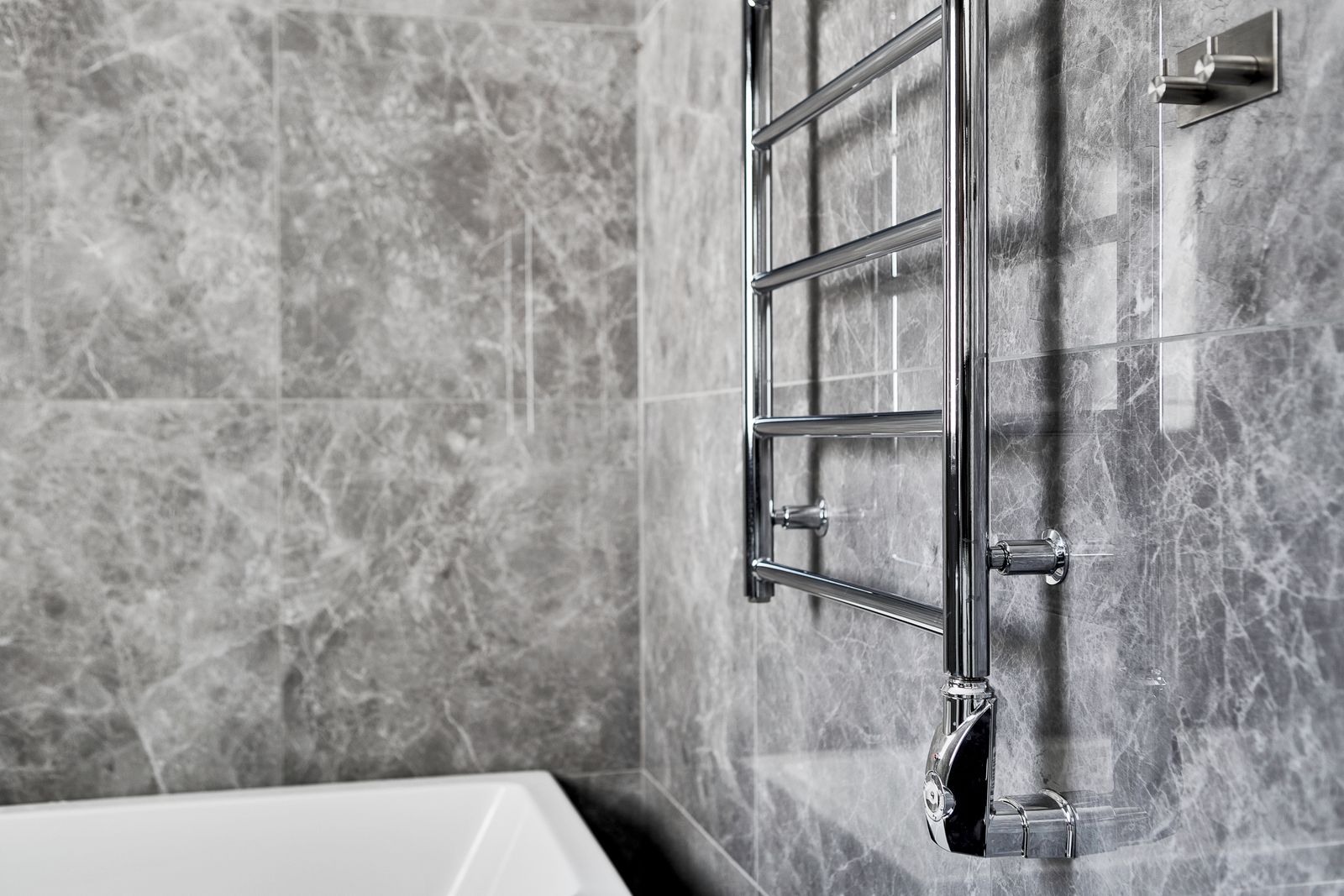 Chrome towel rail on a bathroom wall