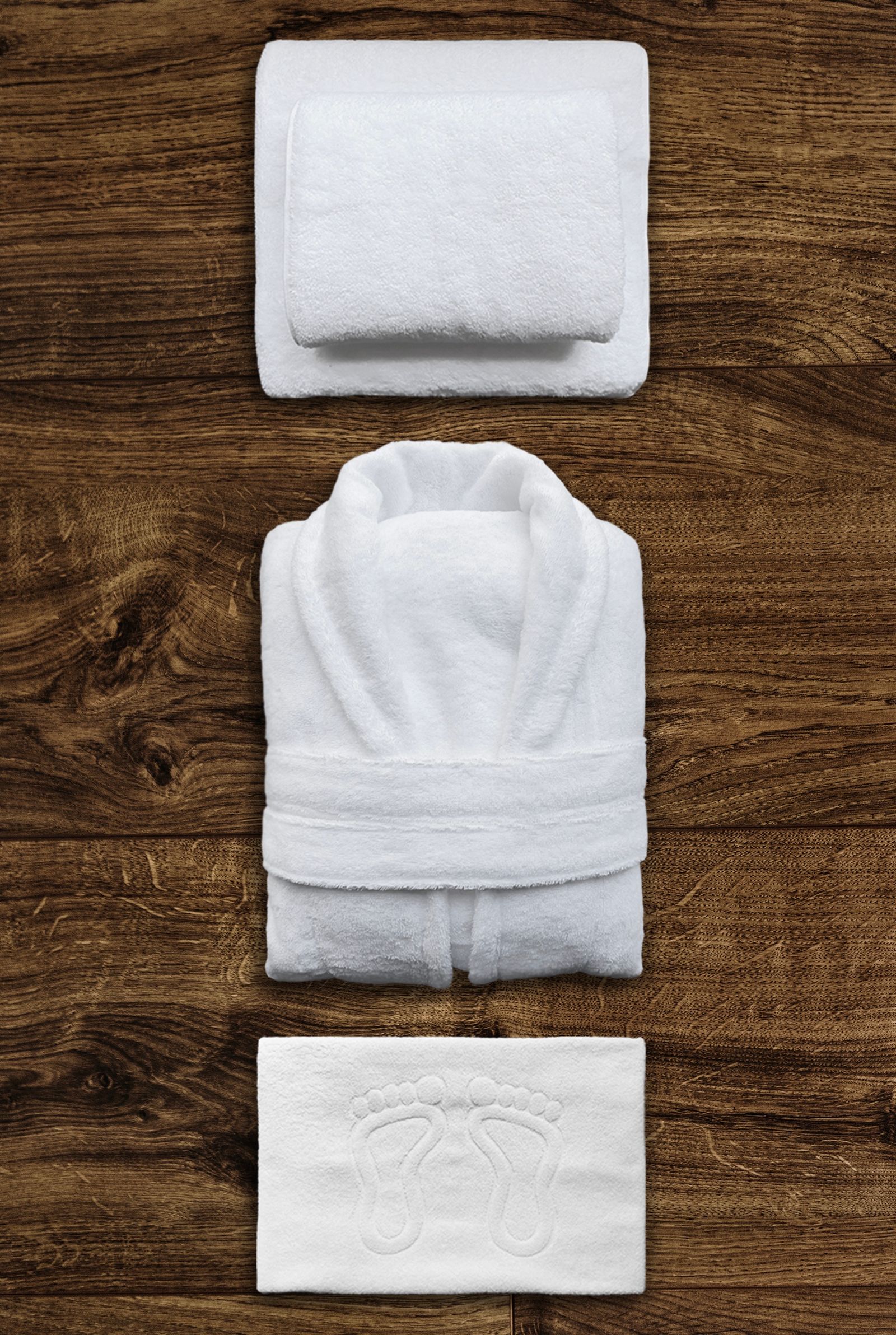 White hotel bathrobe with neatly folded towels